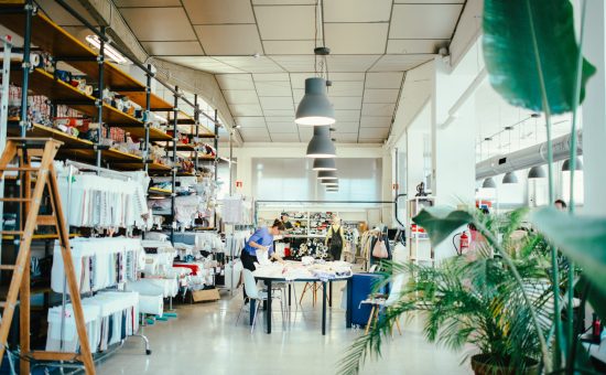Interior of Coleo’s textile design studio with fabrics, samples and people working