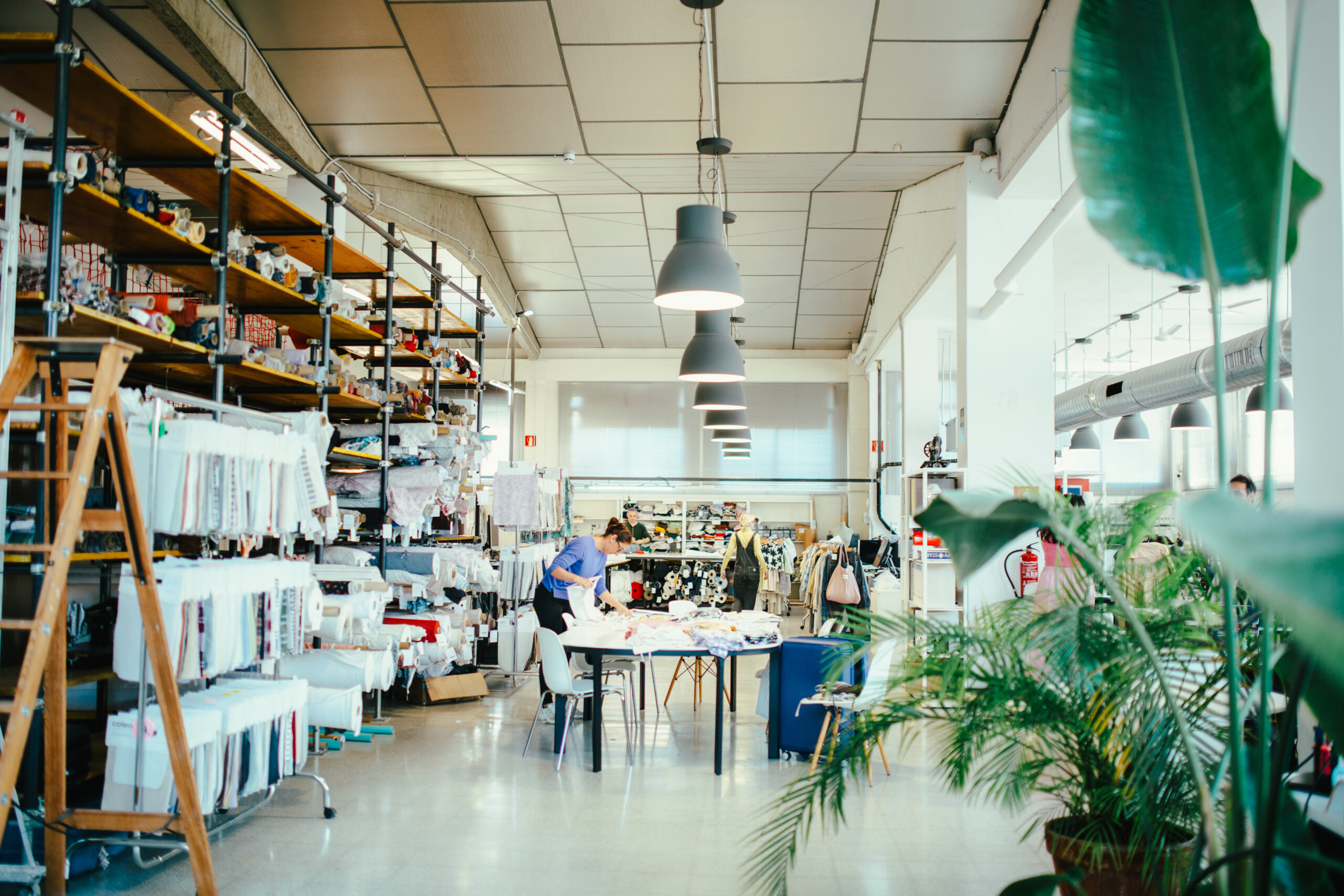 Interior of Coleo’s textile design studio with fabrics, samples and people working